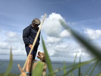 Man standing by sea against sky