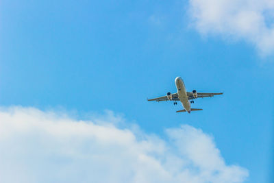 Low angle view of airplane flying in sky