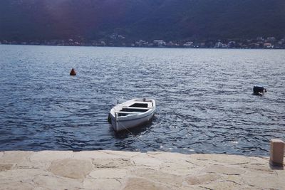 Sailboats moored on sea