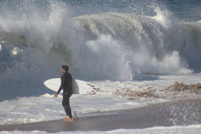 Full length of man standing on sea shore