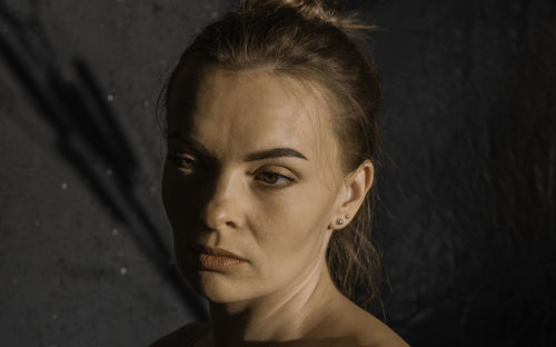 Portrait of a young girl with clean skin on a black background close-up. beautiful woman, makeup