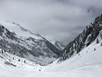 Scenic view of snow covered mountains against sky