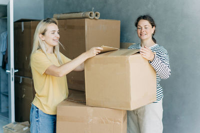 Portrait of smiling woman holding box
