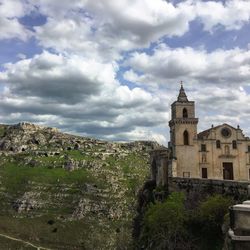 Buildings against cloudy sky