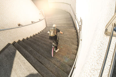 High angle view of man riding bicycle on staircase