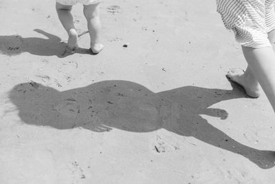 Low section of women standing on beach