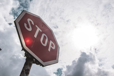 Low angle view of road sign against sky