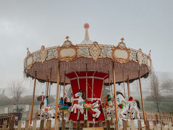 Low angle view of carousel against clear sky