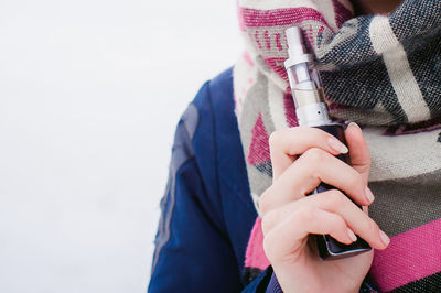 Close-up of woman holding mobile phone