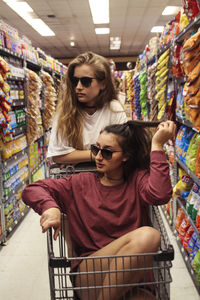 Portrait of young women messing around in supermarket