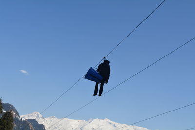 Low angle view of overhead cable car against sky