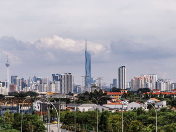 View of residential suburb against kuala lumpur city skyline