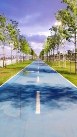 View of empty road against blue sky