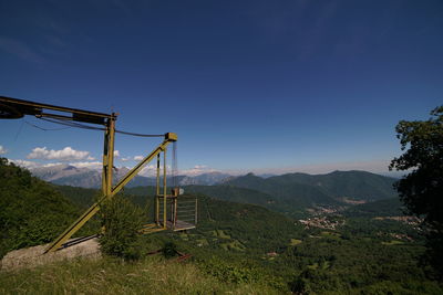 Ski lift against clear blue sky