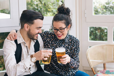 Young couple sitting on table