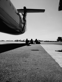 People on runway against sky