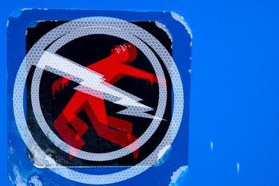 Close-up of stop sign against blue sky