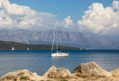 Sailboat sailing on sea against sky