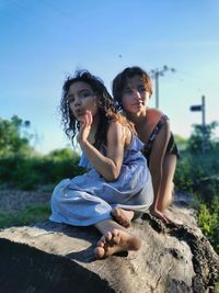 Sisters sat on a rock