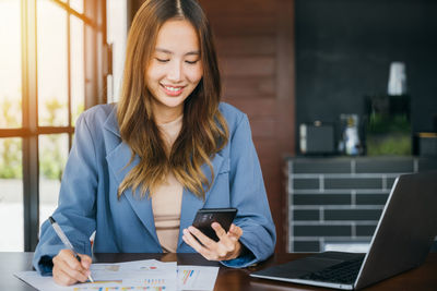 Young businesswoman using mobile phone