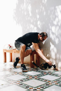 Rear view of woman sitting on table