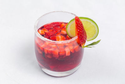 Close-up of strawberries in glass against white background