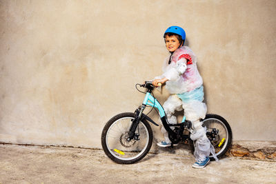 Portrait of smiling young woman riding bicycle