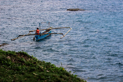 Man rowing boat in sea