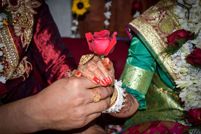 Midsection of couple holding hands