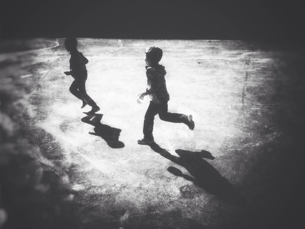 lifestyles, full length, leisure activity, men, water, high angle view, silhouette, childhood, reflection, boys, shadow, walking, sunlight, enjoyment, standing, playing, fun