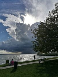 Scenic view of lake against cloudy sky