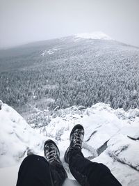 Low section of people on snowcapped mountain