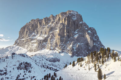 Gorgeous winter morning view of  canazei, dolomites, italy where skiers are about to start a new day