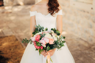 Woman holding flower bouquet