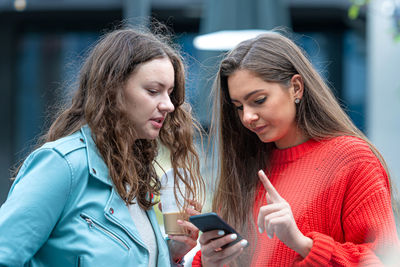 Portrait of a young woman using mobile phone