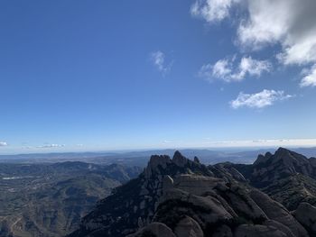 Scenic view of rocky mountains against blue sky