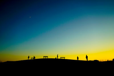 Silhouette woman standing against clear sky during sunset