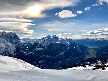 Scenic view of snow covered mountains against sky