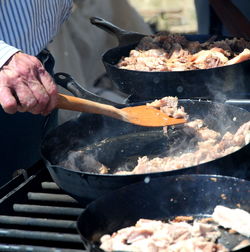 Cropped hand preparing food in pan