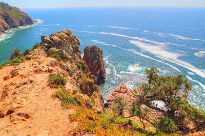 High angle view of rocks on sea shore against sky