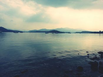Scenic view of lake against cloudy sky