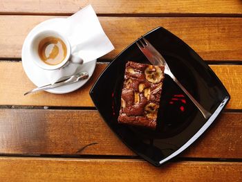 High angle view of coffee and pastry served on table