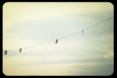 Low angle view of cables against sky