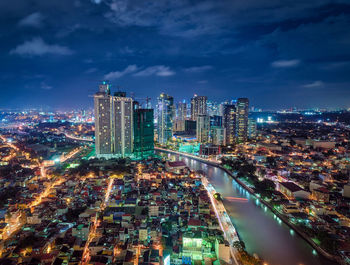 Aerial view of city lit up at night