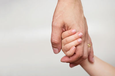 Close-up of woman hand over white background