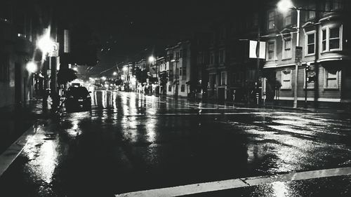 View of wet street at night