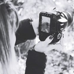 Close-up of woman photographing from camera