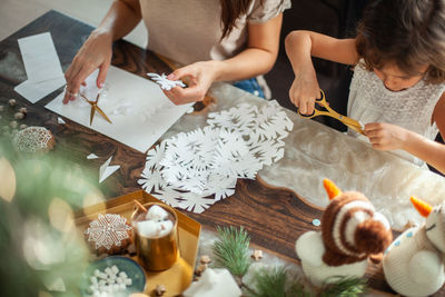 High angle view of people sitting on table