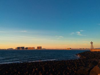 Scenic view of beach against sky during sunset