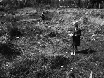 Full length of woman standing on field